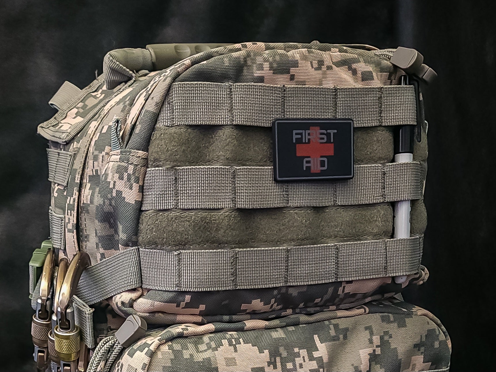 MOLLE Medical ID Tags attached to a tactical backpack for emergency identification and first aid access.